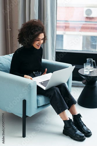 Mixed-race female video calling office from home. photo