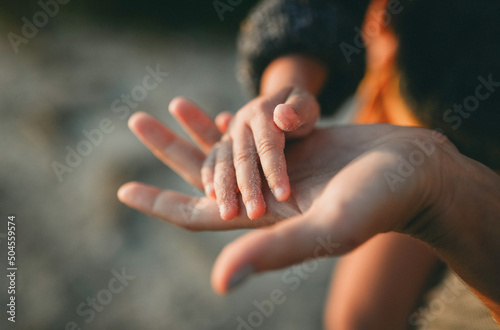 hands of a woman and her little daughter photo