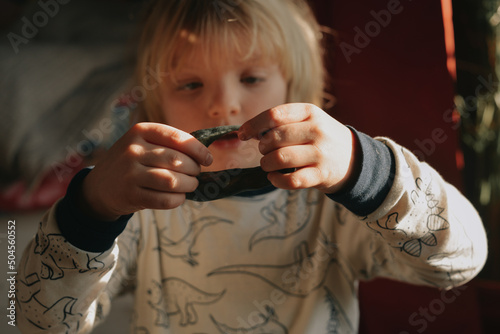 A 5 years old kid playing with modeling clay photo