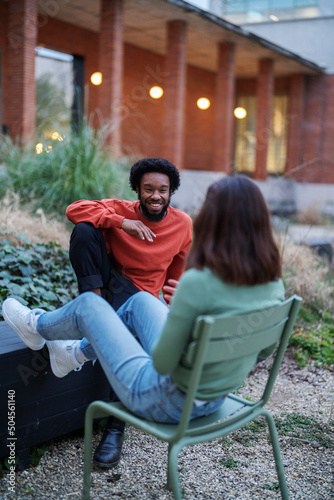 Black man telling story to woman