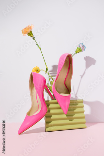 Female high heel sandals and colorful spring flowers. photo