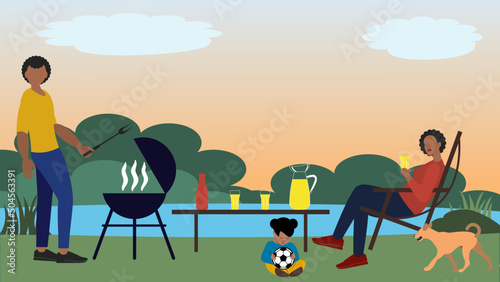 Lakeside African-American family outing  on Juneteenth National Independence Day. Father cooking, mother relaxing, daughter playing
