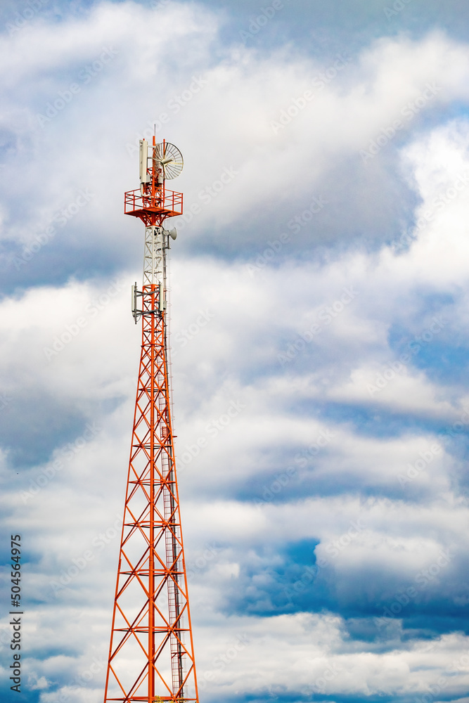 Radio mast (tower) with antennas for telecommunications and broadcasting and stormy cloudy sky. Full length vertical photo Radio mast (tower) with antennas for telecommunications and broadcasting and stormy cloudy sky. Full length vertical photo