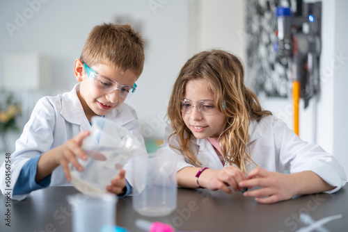 Siblings playing science photo
