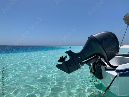 motor of speed boat in Maldives, motorboat in turquoise water of beach