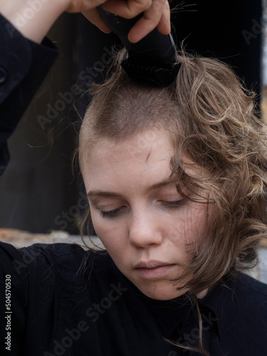 Young girl cuts her head bald photo