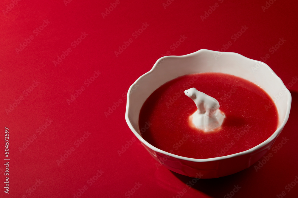 Ceramic polar bear in a ceramic bowl filled with watermelon juice Ceramic polar bear in a ceramic bowl filled with watermelon juice
