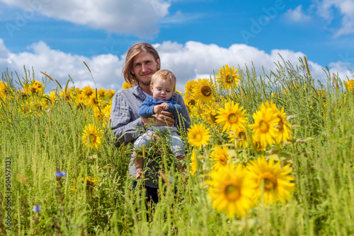 Father and son in sunflower field  photo