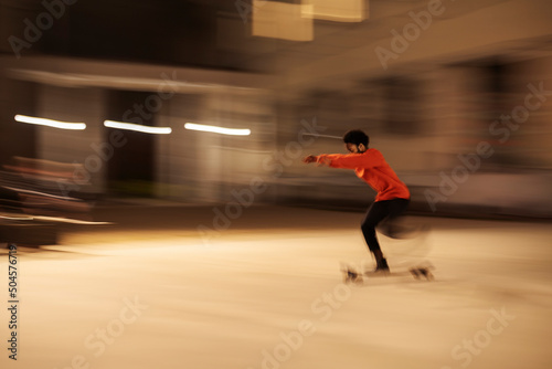 Man riding skateboard in evening photo