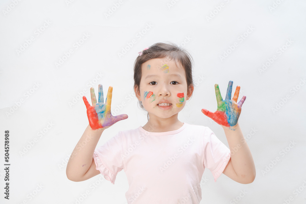 The naughty little girl covered her hands and face with paint The naughty little girl covered her hands and face with paint