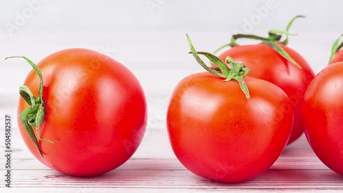 Close-up of fresh ripe tomatoes on a woody background