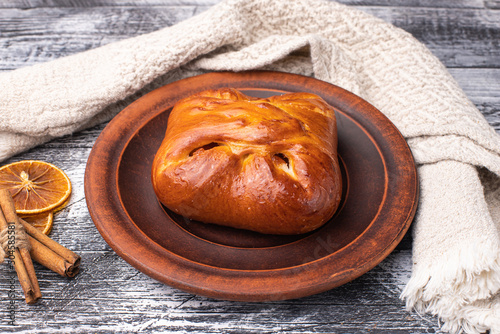 A bun with different fillings, on a white wooden background, a wooden plate