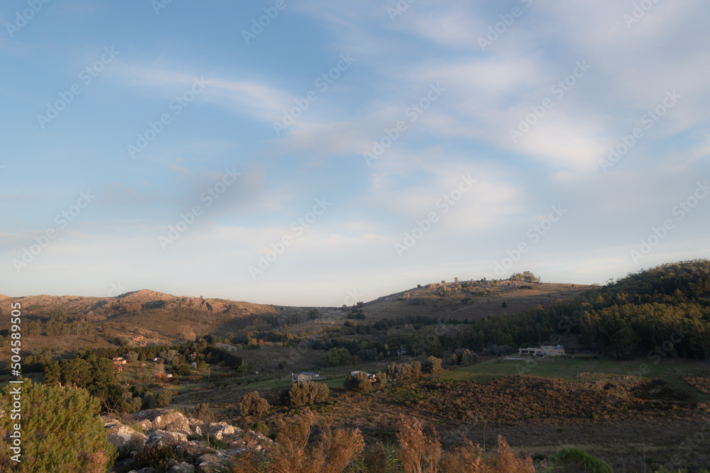 PANORAMIC VIEW OF A MOUNTAIN LANDSCAPE AND A CELESTIAL SKY WITH CLOUDS PANORAMIC VIEW OF A MOUNTAIN LANDSCAPE AND A CELESTIAL SKY WITH CLOUDS