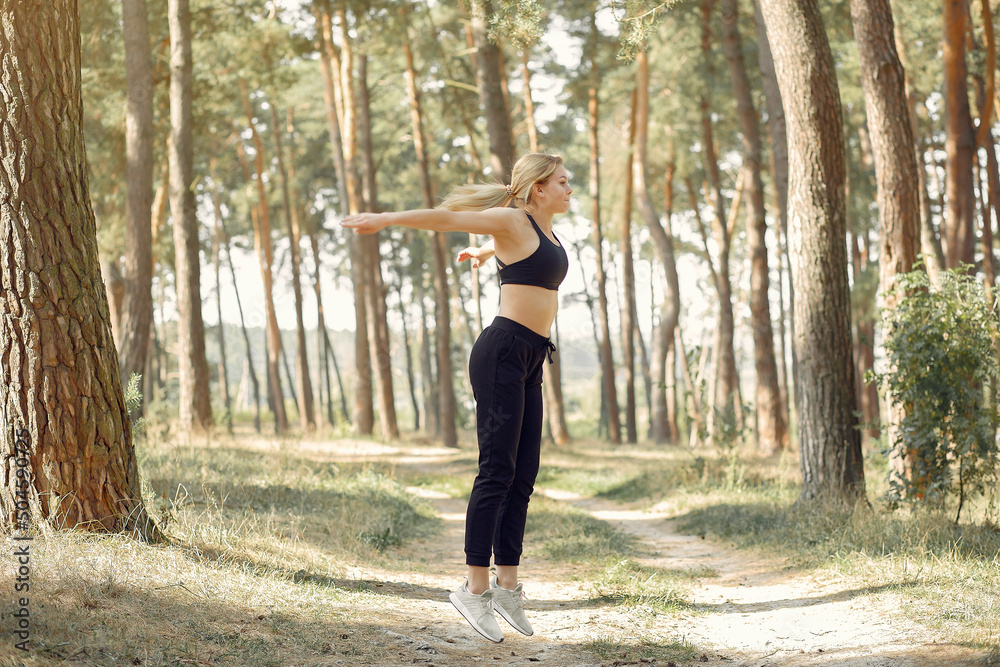 Cute girl doing yoga in a summer forest