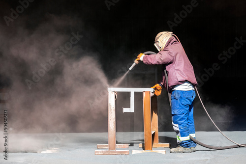 Sandblaster is sandblasting to steel material. Sand blasting is also known as abrasive blasting, which is a generic term for the process of smoothing, shaping and cleaning a hard surface by forcing. photo