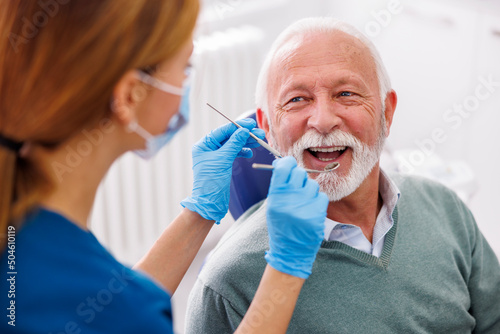 Doctor checking up patient at dentist office