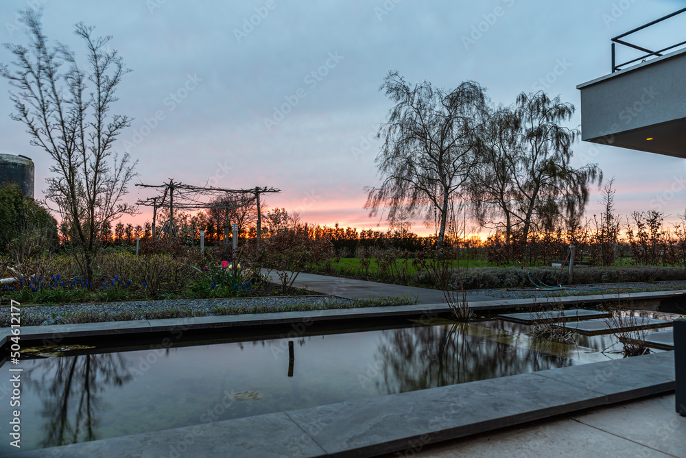 Echt, Limburg, The Netherlands, 04 09 2022 - Reflecting trees in the fountain of a contemporary backyard Echt, Limburg, The Netherlands, 04 09 2022 - Reflecting trees in the fountain of a contemporary backyard