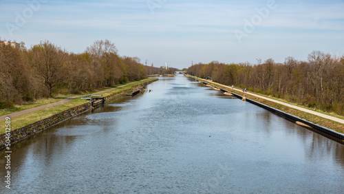 Dilsen, Limburg, Belgium - View from above over the Albert canal with cyclist trails at both sides of the banks photo