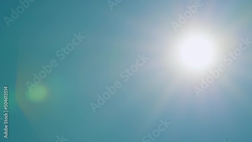 Bright shining sun in a blue sky no clouds. Tropical summer sunlight. Real time.