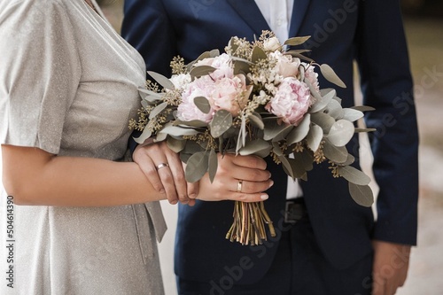 bride and groom holding bouquet flowers