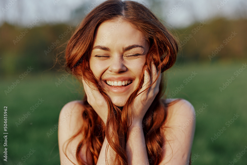 © SHOTPRIME STUDIO - Portrait of a young redheaded woman looking into the camera and smiling, close-up portrait of a laughing woman in the setting sunlight © SHOTPRIME STUDIO - Portrait of a young redheaded woman looking into the camera and smiling, close-up portrait of a laughing woman in the setting sunlight