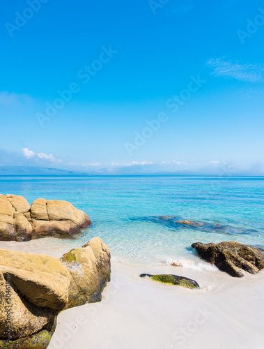 Paradise beach with turquoise waters and calm sea with white sand and small rocks. Ideal for traveling and getting lost. Galicia, Spain