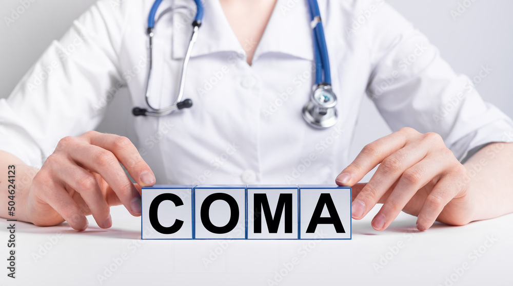 Coma word on medical cubes in doctor hands. High quality photo Coma word on medical cubes in doctor hands. High quality photo