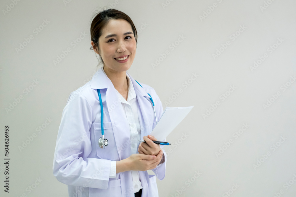 Young Female Doctor in White Uniform. Woman doctor with stethoscope. General practitioner holding a medical record. Asian Female Doctor. Young Female Doctor in White Uniform. Woman doctor with stethoscope. General practitioner holding a medical record. Asian Female Doctor.