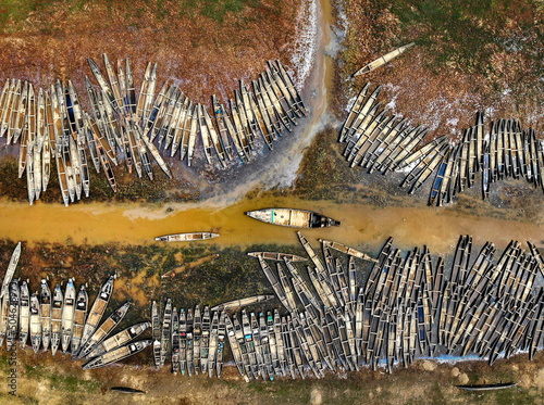 Fishing boats are arranged in river shore photo