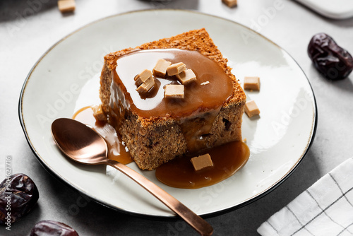 Obraz na plátně Easy Sticky Toffee Pudding is a deliciously gooey sponge cake drenched in warm toffee sauce that’s a favorite among the English