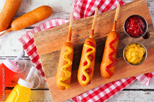 Photography Corn dogs with mustard and ketchup