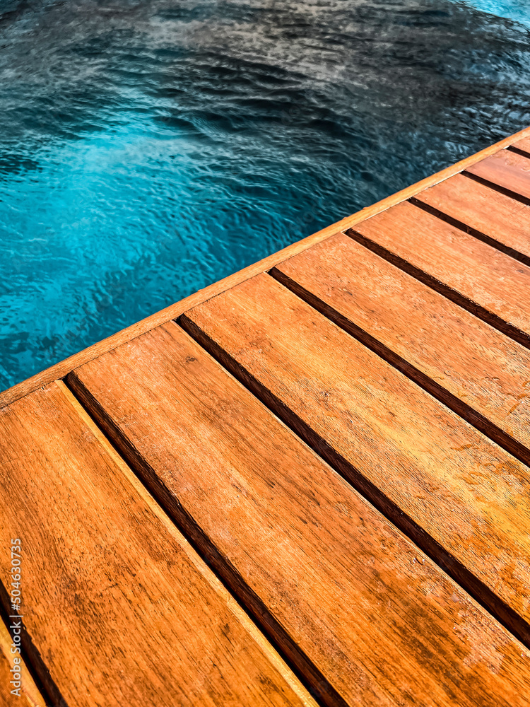 Wooden deck by the pool in close up for background.