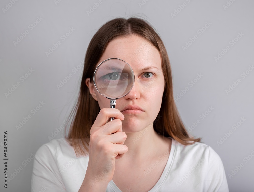 Eye problem, disease concept. Pain, ache and eyesight checking. Woman with magnifying lens. High quality photo Eye problem, disease concept. Pain, ache and eyesight checking. Woman with magnifying lens. High quality photo
