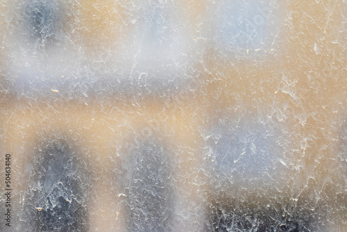 The window glass in the house is dirty after a sandstorm.