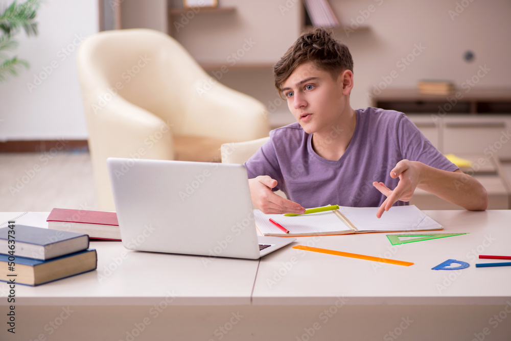Schoolboy preparing for exams at home Schoolboy preparing for exams at home