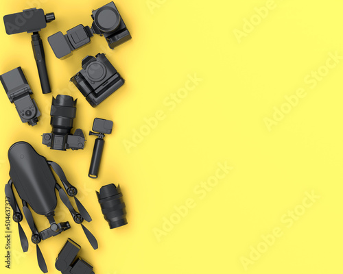 Top view of monochrome designer workspace and photography gear on yellow