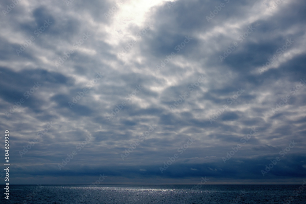 Dramatic stormy dark cloudy sky over sea, natural photo background Dramatic stormy dark cloudy sky over sea, natural photo background