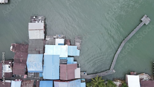 Georgetown, Penang Malaysia - May 13, 2022: The Clan Jetties of Georgetown Penang, Malaysia. Wooden villages built on stilts at the sea coast by the different clans of the Penang Chinese community. photo