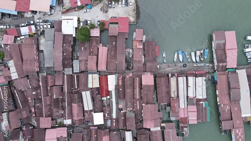 Georgetown, Penang Malaysia - May 13, 2022: The Clan Jetties of Georgetown Penang, Malaysia. Wooden villages built on stilts at the sea coast by the different clans of the Penang Chinese community. photo