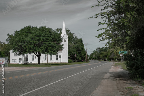 A church with a steeple in Madisonville, Texas photo