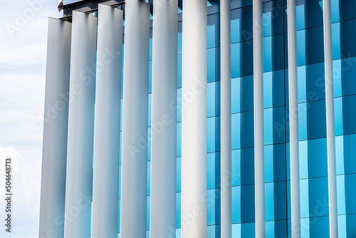 The facade of a modern building with an innovative facade made of automatic, movable blinds.
