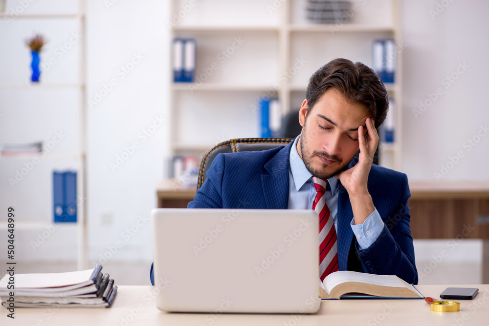Young male employee working in the office Young male employee working in the office