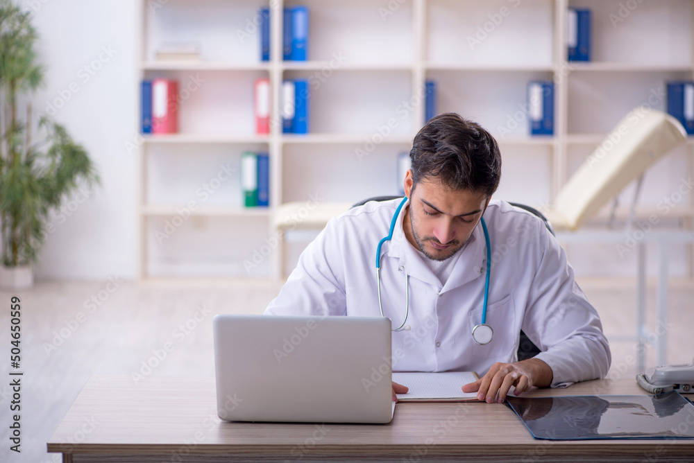 Young male doctor working in the clinic Young male doctor working in the clinic