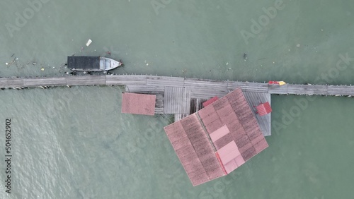 Georgetown, Penang Malaysia - May 13, 2022: The Clan Jetties of Georgetown Penang, Malaysia. Wooden villages built on stilts at the sea coast by the different clans of the Penang Chinese community. photo