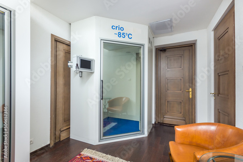 A bright room of a country house with doors and a home cryosauna. photo