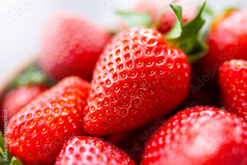 Juicy ripe strawberries  close-up. Summer farm harvest berries. Healthy natural raw vegan food.