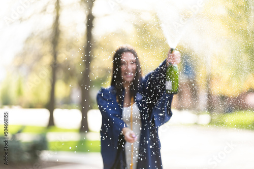 college graduate spraying champagne