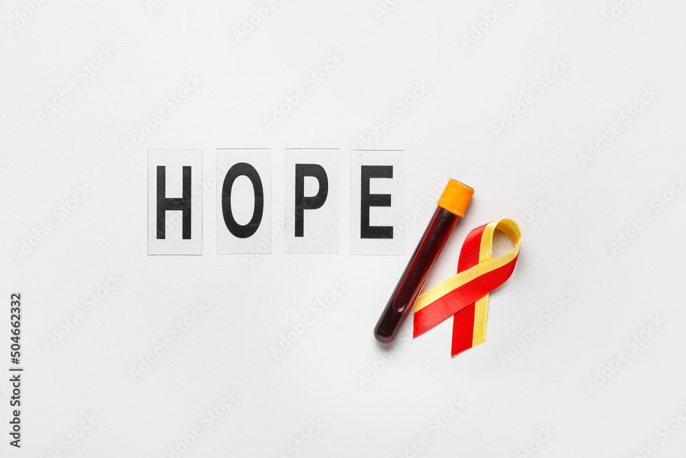 Awareness ribbon with blood sample and word HOPE on light background. Hepatitis concept Awareness ribbon with blood sample and word HOPE on light background. Hepatitis concept