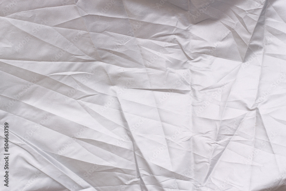 Fototapeta premium crumpled fabric as a textured grey background
