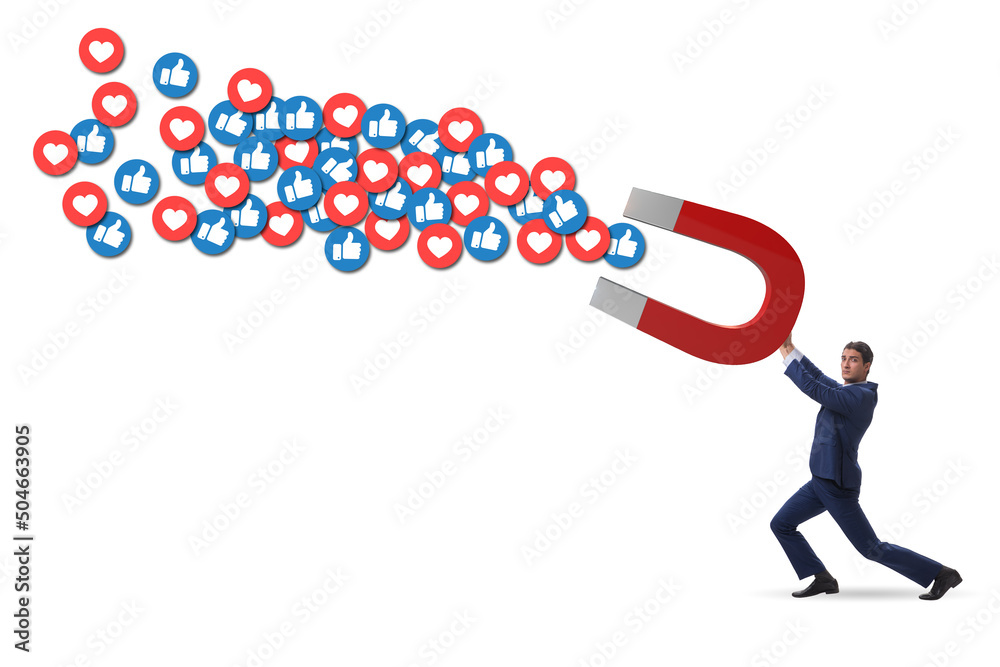 Businessman attracting likes with large magnet Businessman attracting likes with large magnet